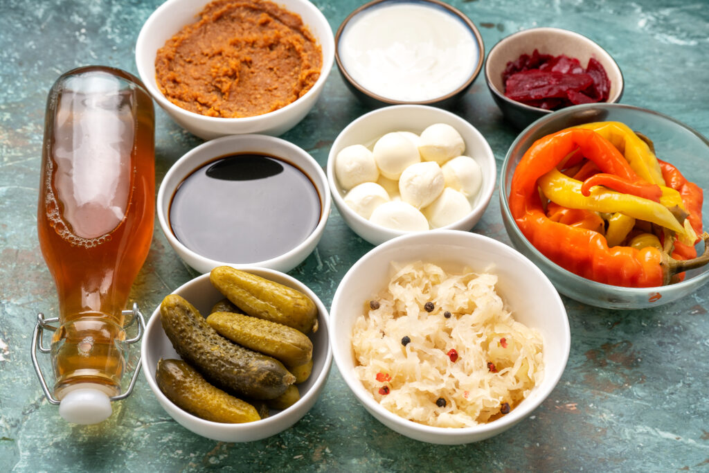 Close up of variety fermented foods on light mint background. Healthy food concept for strong immunity and human microbiome